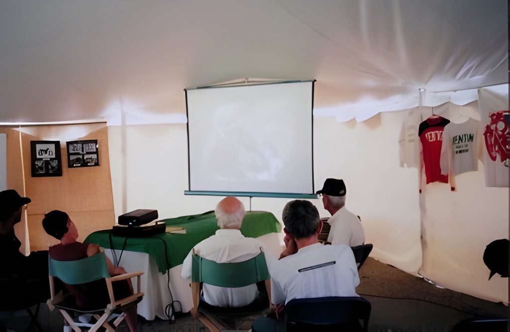 People watching a film in a tent event.