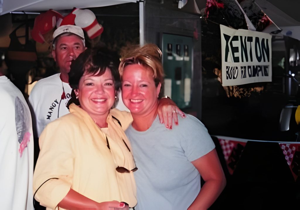 Two women smiling at an outdoor event.