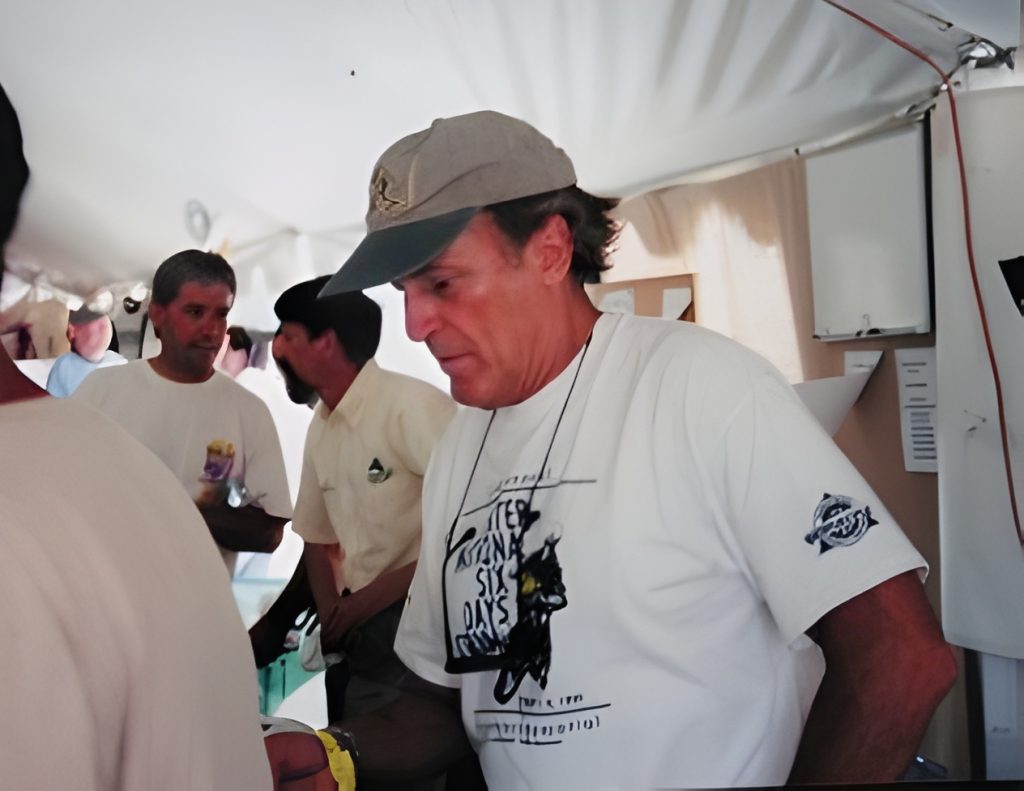 Men inside a tent at an event.