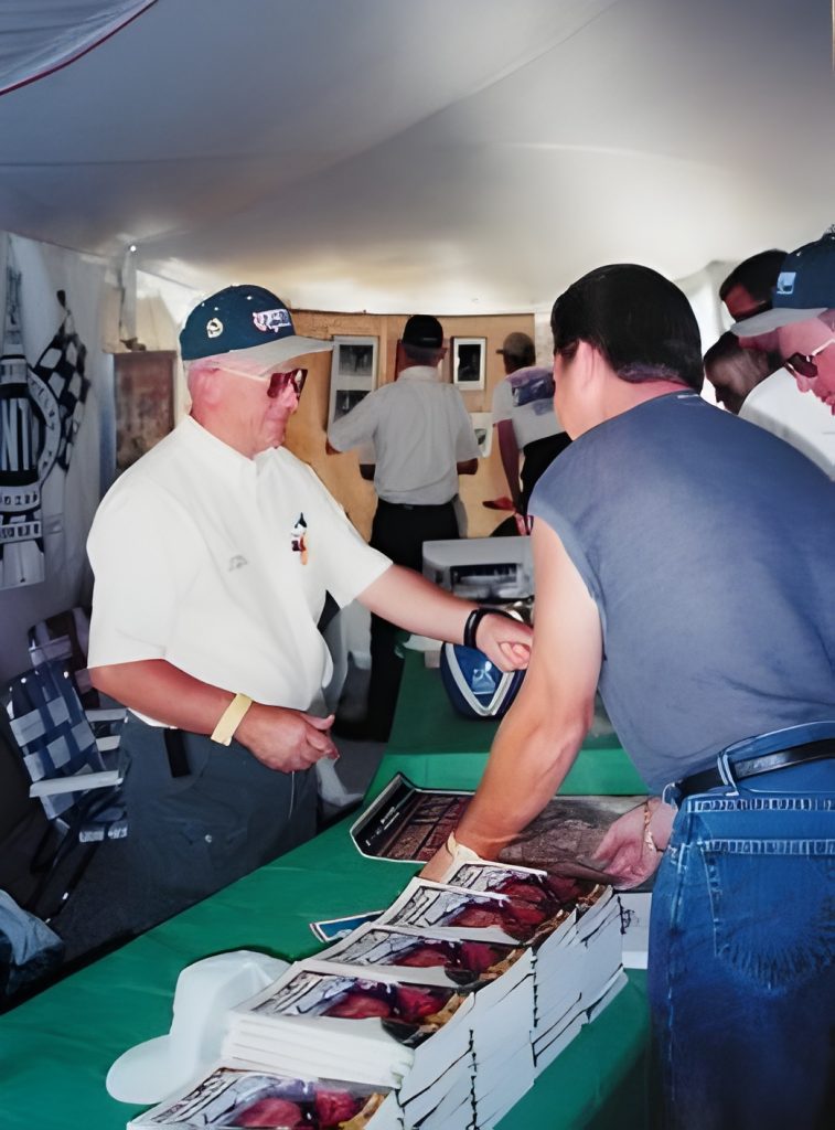 People exchanging autographs at book signing event