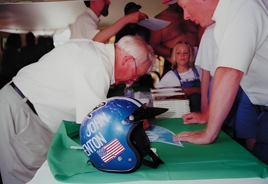 Event attendees with blue helmet on table.