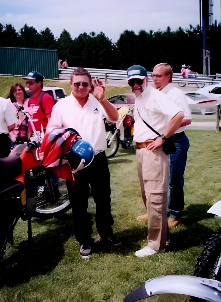 Group of people at motorcycle event outdoors.