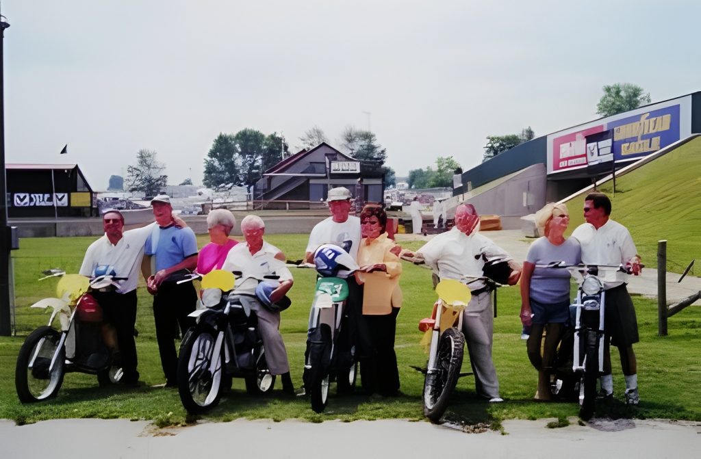 Group of people with motorcycles outdoors