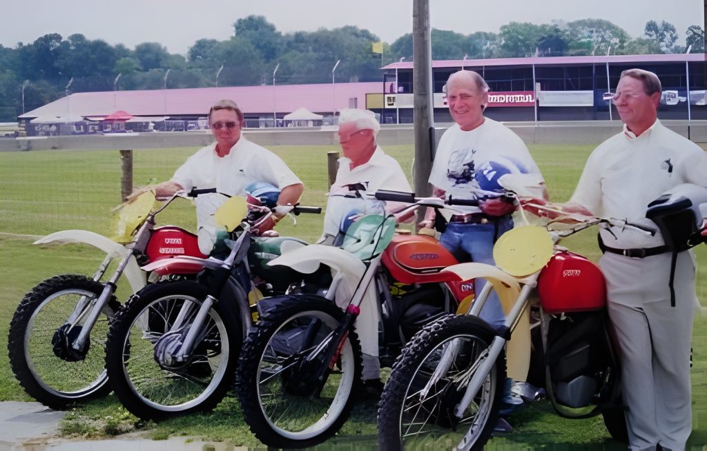 Group with vintage motorcycles at a race track