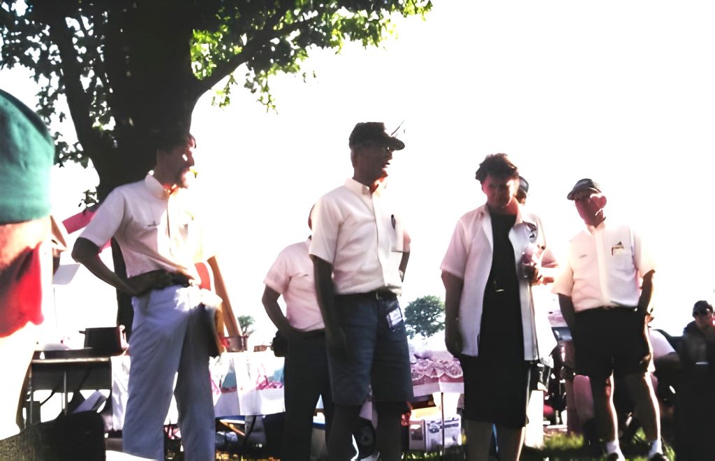 Group of people outdoors at a gathering.