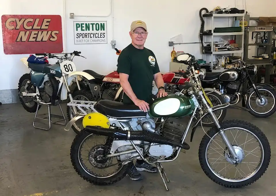 Man with vintage motorcycles in a workshop
