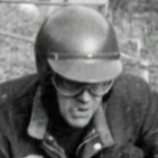 Person in helmet and goggles, black and white photo.